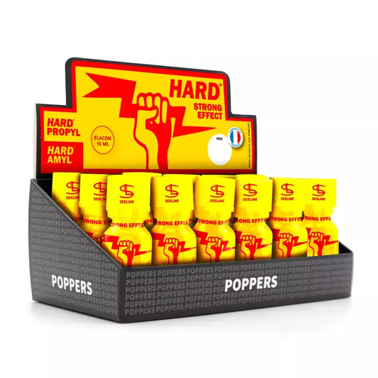 on voit sur un fond blanc n présentoir en carton du poppers Hard. Le carton est noir jaune et rouge les flacons sont jaunes avec une main rouge tenant un éclair rouge.